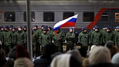 Soldiers who were recently mobilised by Russia for war in Ukraine stand at a ceremony before boarding a train at a railway station in Tyumen, 2 December 2022
