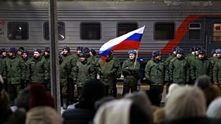 Soldiers who were recently mobilised by Russia for war in Ukraine stand at a ceremony before boarding a train at a railway station in Tyumen, 2 December 2022