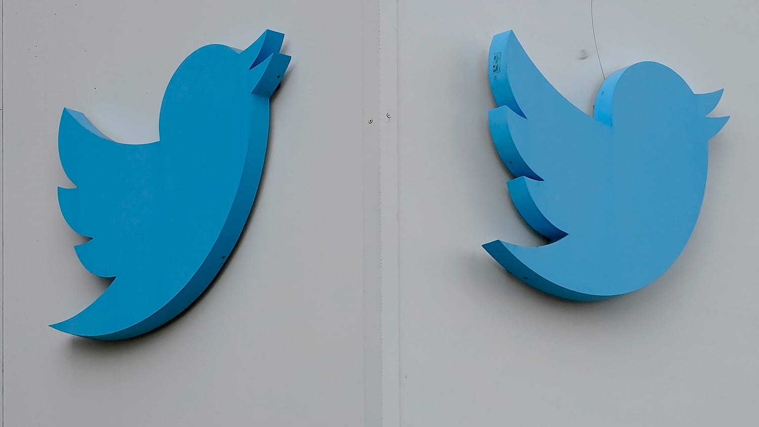 Twitter logos hang outside the company's offices in San Francisco, Monday, Dec. 19, 2022.