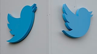 Twitter logos hang outside the company's offices in San Francisco, Monday, Dec. 19, 2022.