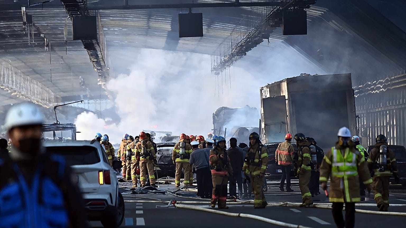 Pompiers  et secouristes sur les lieux d'incendie qui s'est déclaré dans un un tunnel autoroutier à Seoul, le 29 décembre 2022