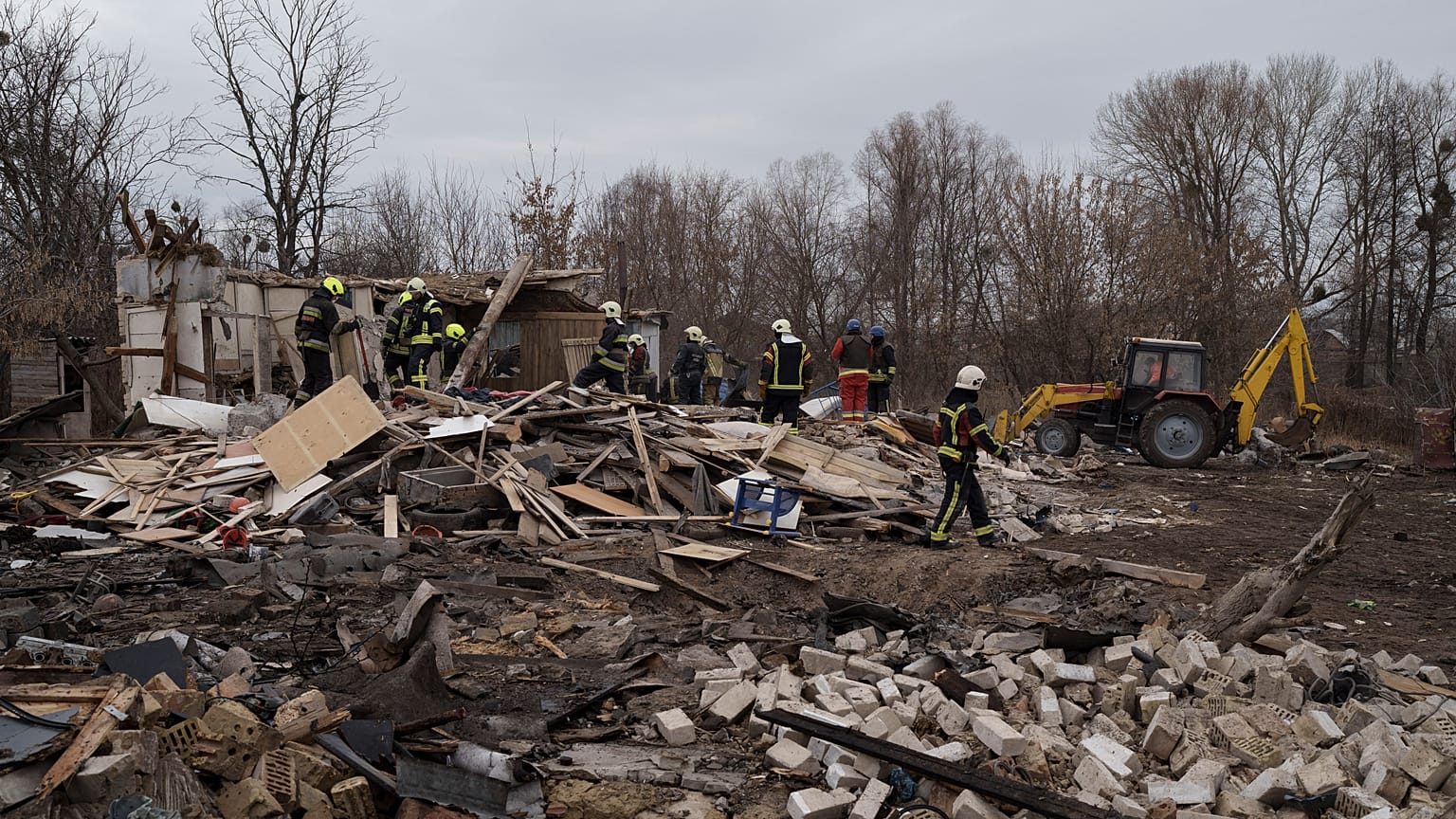 Emergency workers remove debris of a house destroyed following a Russian missile strike in Kyiv, Ukraine, Thursday, Dec. 29, 2022.