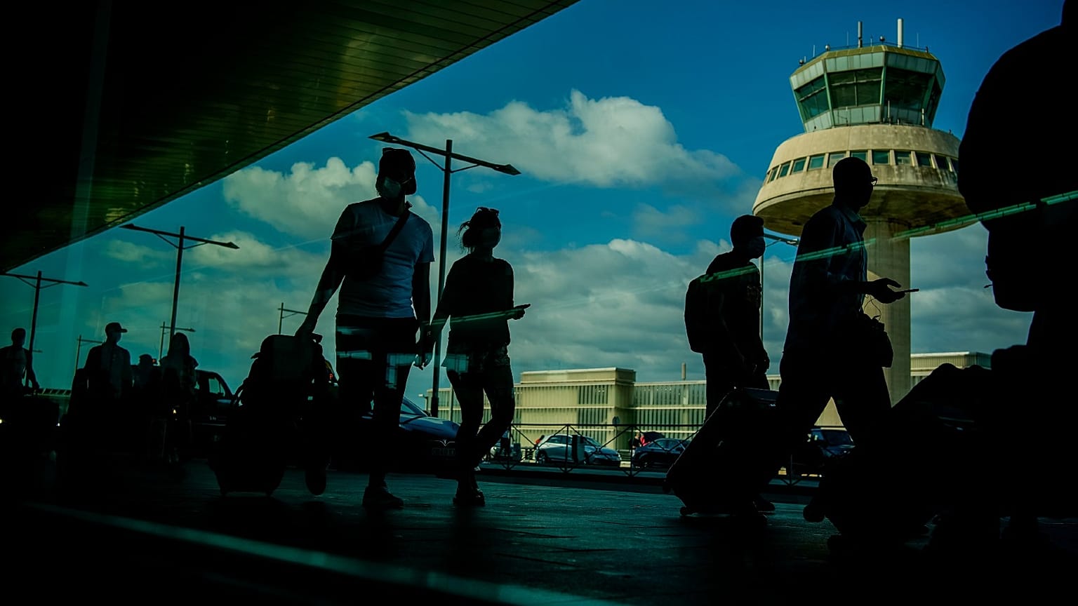 Passengers carry luggage at the Barcelona airport, Spain, on July 9, 2021. 