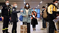 Passengers on a flight from China get COVID documents checked at after arriving at the Paris-Charles-de-Gaulle airport, Sunday 1 January 2023