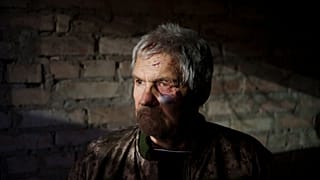 Anatolii Kaharlytskyi, 73, stands inside his house, heavily damaged after a Russian attack in Kyiv, Ukraine, Monday, Jan. 2, 2023. 
