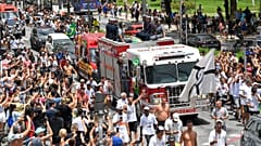 The remains of late Brazilian soccer great Pele are transported on a firetruck from Vila Belmiro stadium to the cemetery during his funeral procession in Santos, Brazil