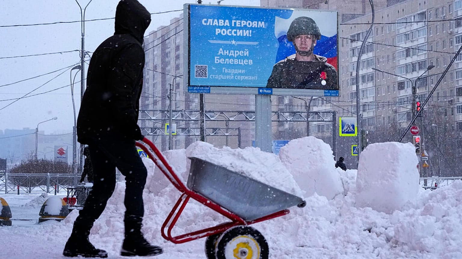 A billboard with a portrait of a Russian soldier awarded for action in Ukraine and the words "Glory to the heroes of Russia" in St. Petersburg, Russia, Tuesday, Jan. 3, 2023.