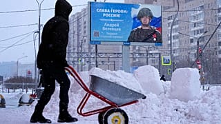 A billboard with a portrait of a Russian soldier awarded for action in Ukraine and the words "Glory to the heroes of Russia" in St. Petersburg, Russia, Tuesday, Jan. 3, 2023.