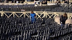 Workers clean seating put in place for the funeral, in St. Peter's Square at the Vatican, Wednesday, Jan. 4, 2023.