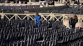 Workers clean seating put in place for the funeral, in St. Peter's Square at the Vatican, Wednesday, Jan. 4, 2023.