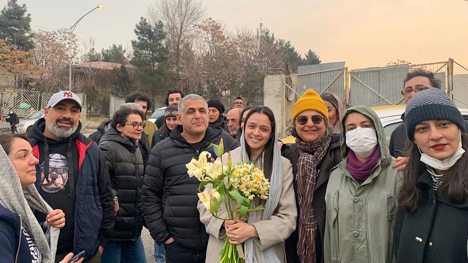 Iranian prominent actress Taraneh Alidoosti, center, holds bunches of flowers as she poses for a photo after being released from Evin prison in Tehran, 4 January 2023