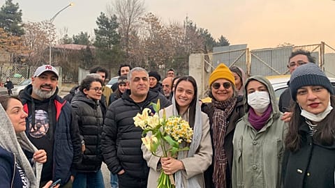 Iranian prominent actress Taraneh Alidoosti, center, holds bunches of flowers as she poses for a photo after being released from Evin prison in Tehran, 4 January 2023