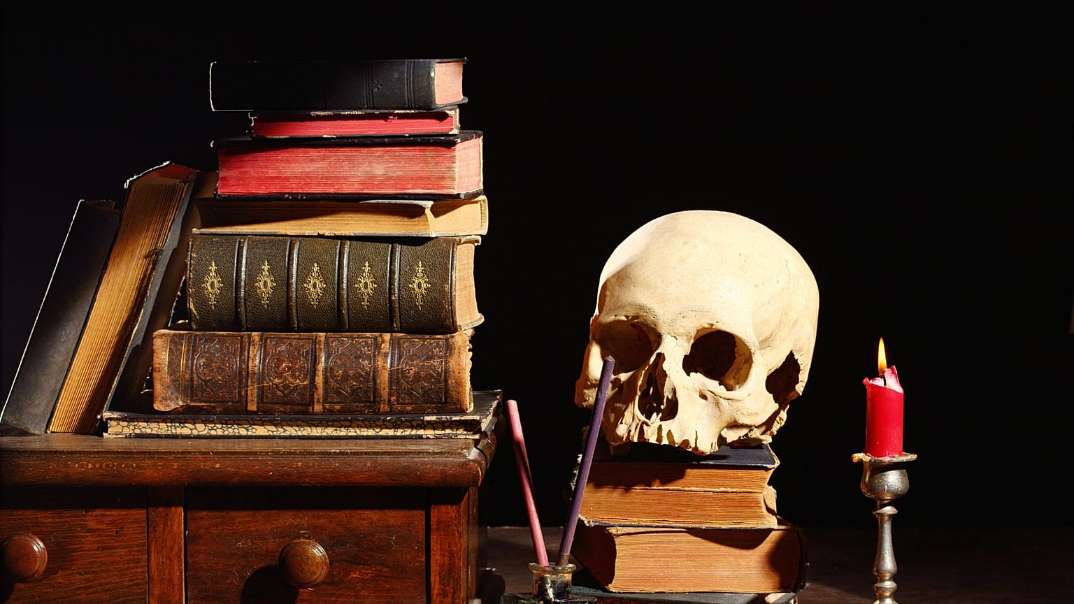 A skull beside a pile of books