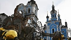 Destroyed domes lie next to a damaged church in the retaken village of Bohorodychne, eastern Ukraine, 22 October 2022