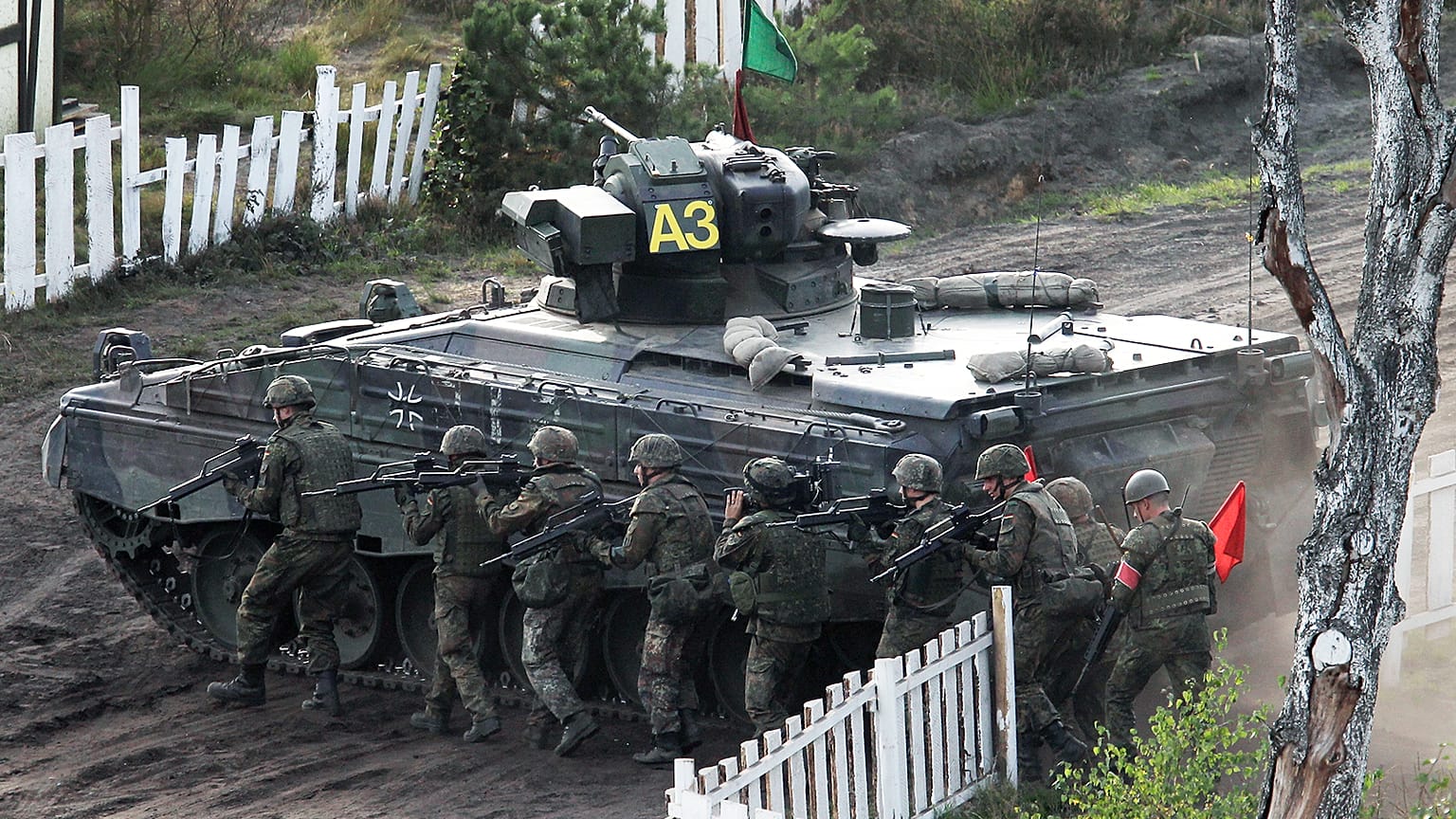 Soldiers follow a Marder infantry fighting vehicle during a demonstration event held for the media by the German Bundeswehr in Bergen near Hannover, September 2011