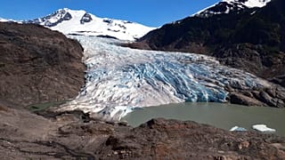 Chunks of ice float on Mendenhall Lake in front of the Mendenhall Glacier on Monday, May 30, 2022, in Juneau, Alaska.