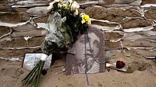 FILE: A religious picture lies on sandbags covering the historical monument of Princess Olga in Kyiv, 6 January 2023