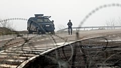 Kosovo police officers guard checkpoint on the road near the northern Kosovo border crossing of Jarinje, along the Kosovo-Serbia border, 30 December 2022