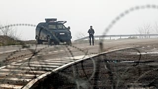 Kosovo police officers guard checkpoint on the road near the northern Kosovo border crossing of Jarinje, along the Kosovo-Serbia border, 30 December 2022