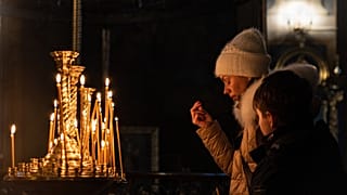 Worshippers pray at the Ukrainian Orthodox Saint Michael's Golden-Domed Monastery in Kyiv on January 6, 2023