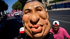 Protestors push an effigy of Portuguese Prime Minister Antonio Costa towards the parliament during a demonstration by workers' unions in Lisbon, July 2022.