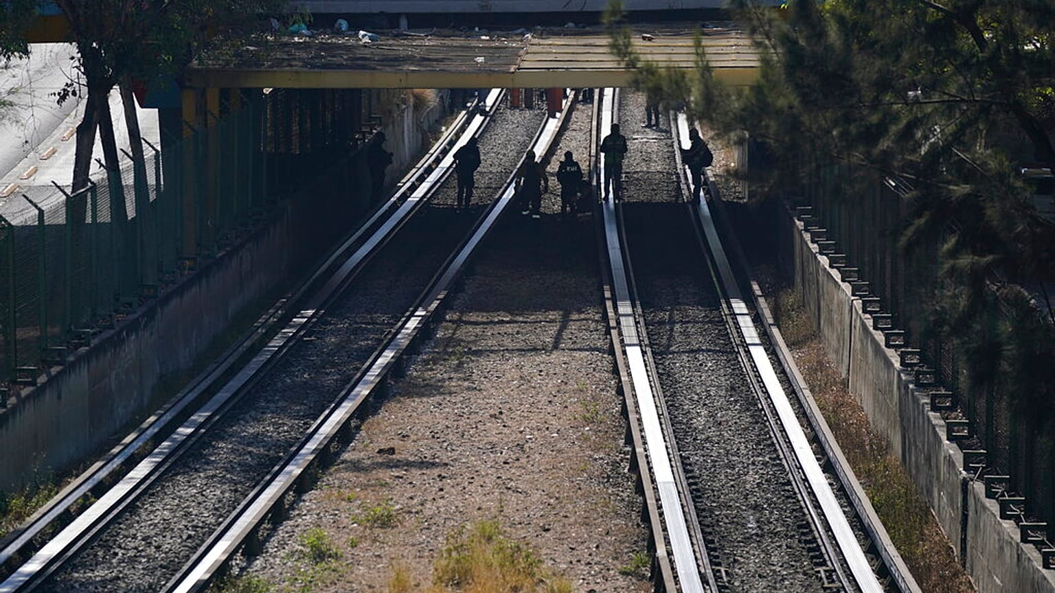 Rescue workers inspect rail lines after two subway trains collided