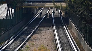 Rescue workers inspect rail lines after two subway trains collided