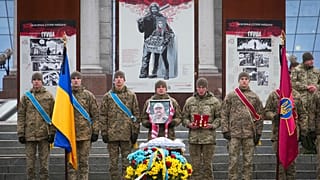 Ukrainian servicemen pay their last respect at the coffin of their comrade Oleh Yurchenko killed in a battlefield with Russian forces in the Donetsk, during a ceremony, 8 Jan.