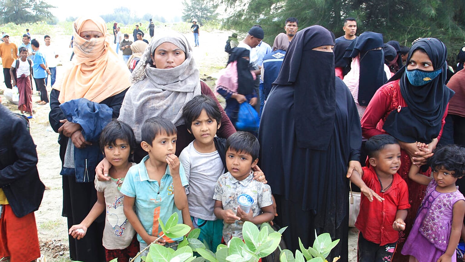 Rohingya refugees gather after they arrived on Lamnga beach in Aceh province, Indonesia, Sunday, Jan. 8, 2023. 