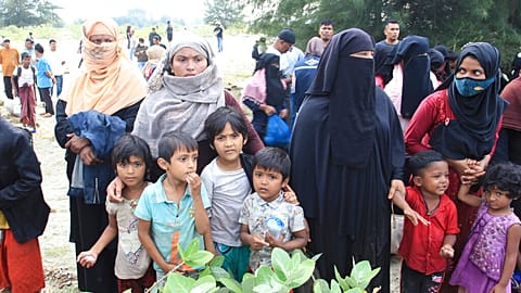 Rohingya refugees gather after they arrived on Lamnga beach in Aceh province, Indonesia, Sunday, Jan. 8, 2023. 