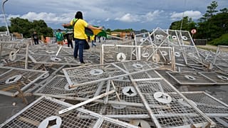 Protesters, supporters of Brazil's former President Jair Bolsonaro, stand over barricades as they storm the Planalto Palace in Brasilia, Brazil.
