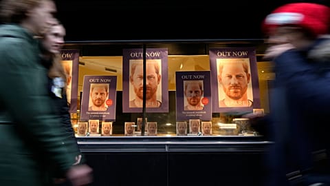 Pedestrians pass a display in the window of a book shop in London on Tuesday. 