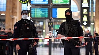 French police stand guard in a cordonned off area at Paris' Gare du Nord train station, 11 January 2023
