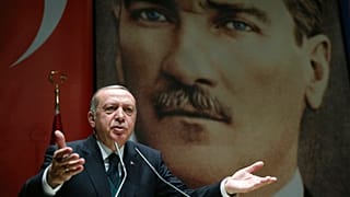 Turkey's President Recep Tayyip Erdogan, gestures as he delivers a speech in Ankara, Friday, March 30, 2018. 