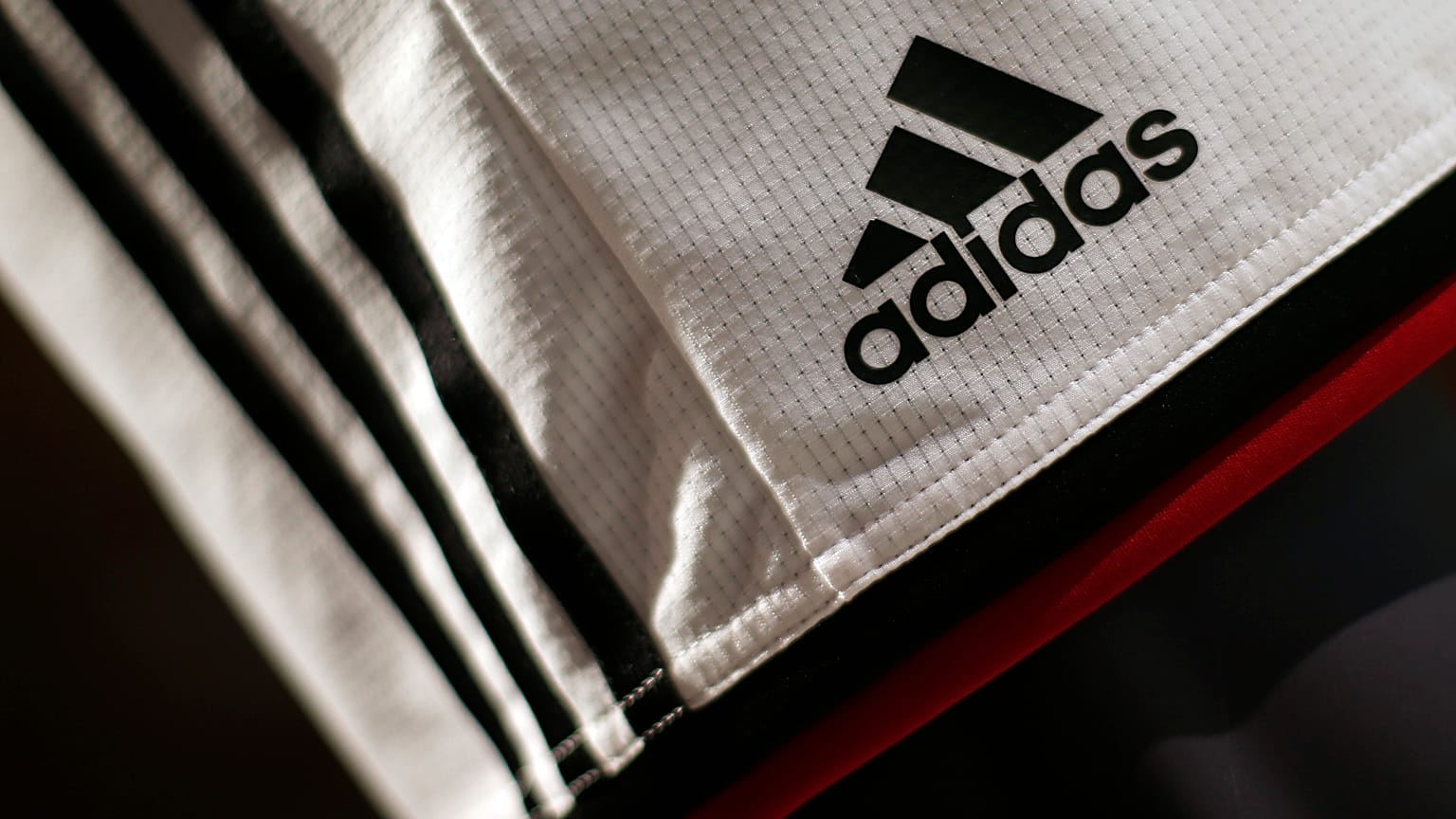 The Adidas logo on a pair of shorts