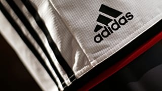The Adidas logo on a pair of shorts