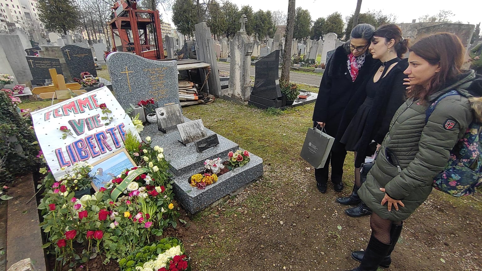 Moradi's wife and loved ones stand around his grave, 13 Friday, Jan, 2023.