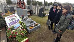 Moradi's wife and loved ones stand around his grave, 13 Friday, Jan, 2023.