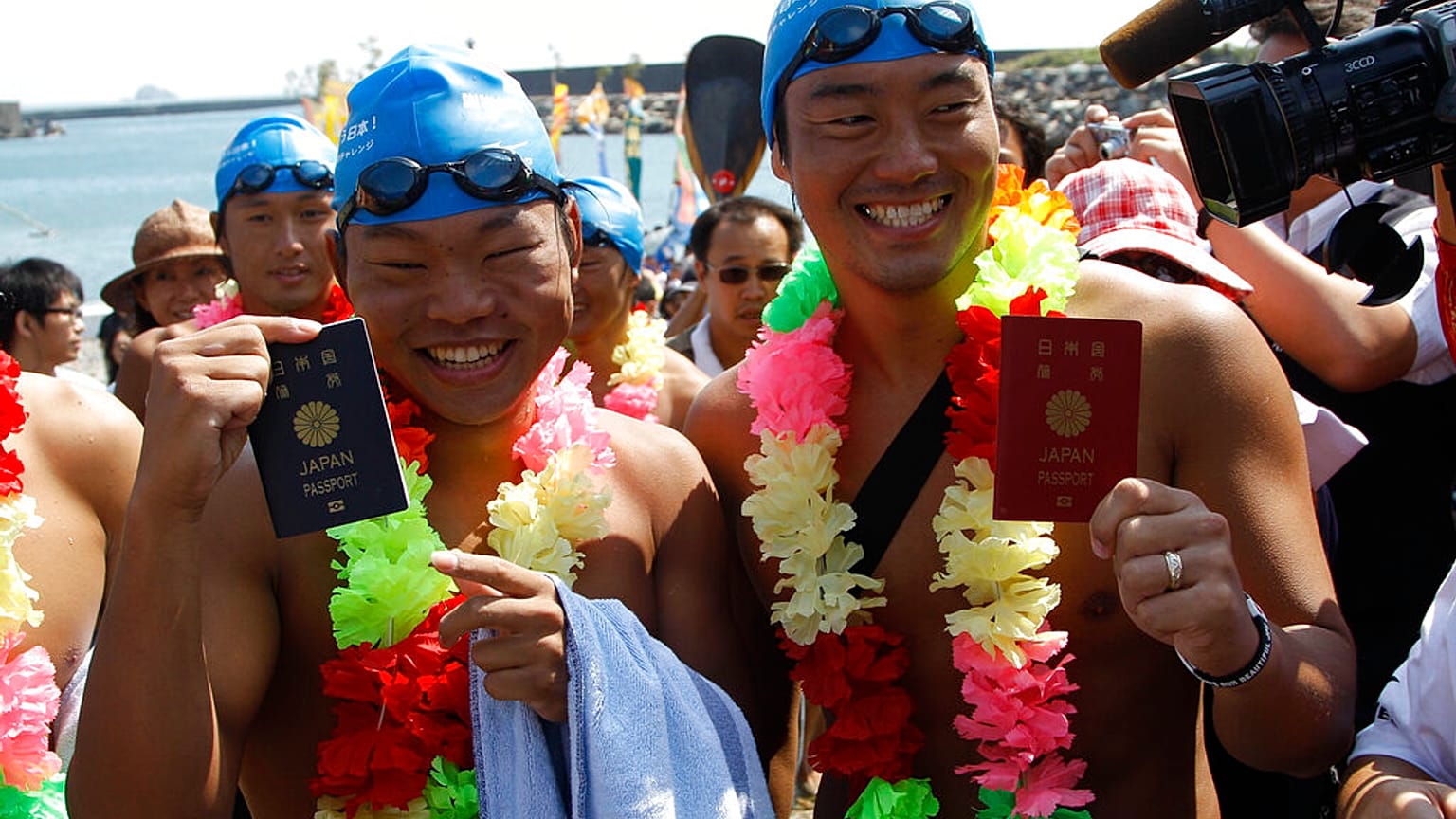 Schwimmer aus Japan mit ihren Pässen: Japanische Pässe führen laut Henley-Liste visafrei in die meisten Länder der Welt - ARCHIVBILD