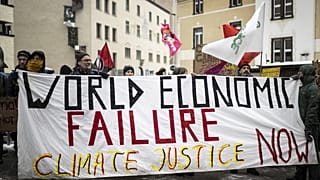 People attend a climate protest rally by Swiss party Juso and Strike WEF on the eve of the 52nd annual meeting of the World Economic Forum in Davos.