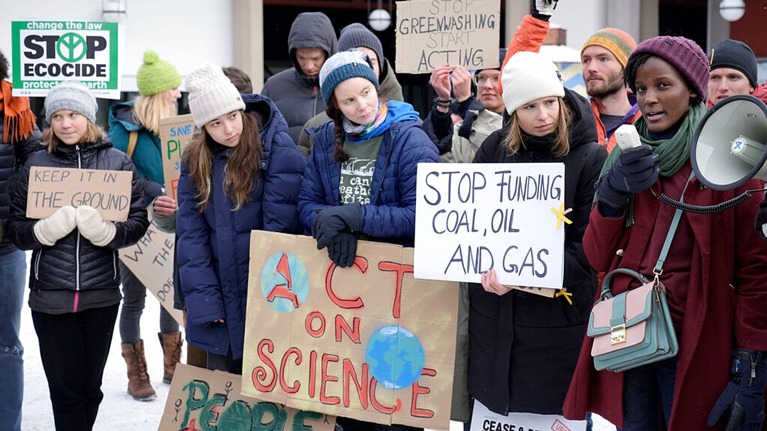 Activist Vanessa Nakate, right, speaks beside Luisa Neubauer, Greta Thunberg and Helena Gualinga among other activists at a climate protest outside the World Economic Forum.