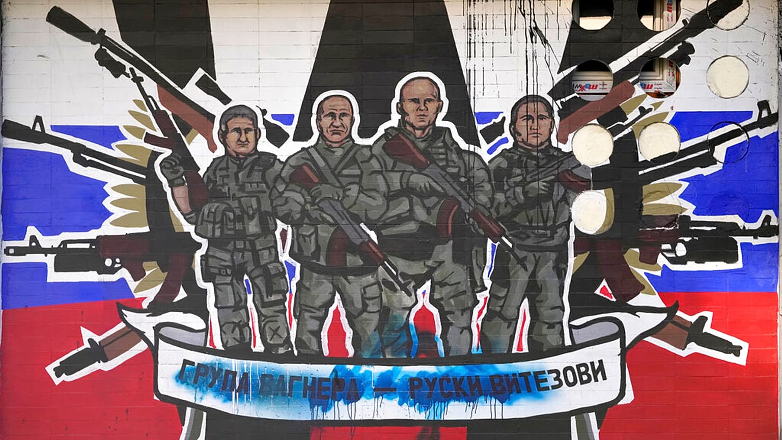 A mural depicting mercenaries of Russia's Wagner Group that reads: "Wagner Group - Russian knights" vandalised with paint on a wall in Belgrade, Serbia, Friday, Jan. 13, 2023.