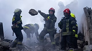 Rescue workers clear rubble from an apartment building which was destroyed by a Russian rocket attack at residential neighbourhood in the southeastern city of Dnipro, Ukraine.