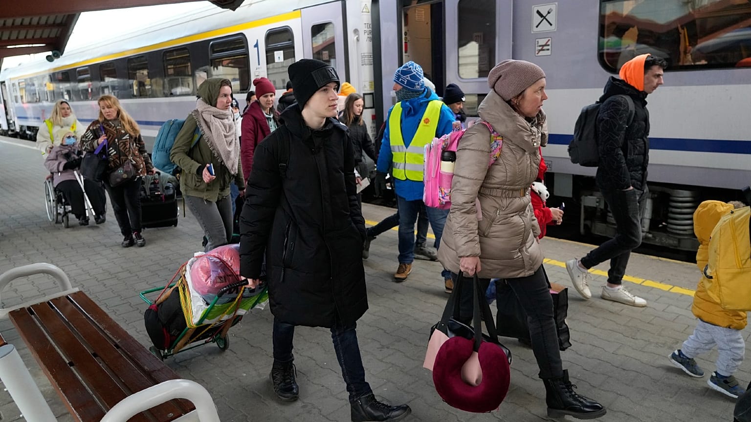 Refugees with children walk along a platform after fleeing the war from neighboring Ukraine at a railway station in Przemysl, Poland, on March 25, 2022.