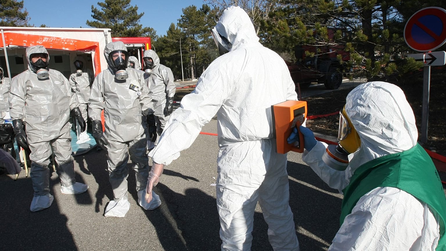 Members of the Radio Protection service wear protective suits and measure radioactivity on a person during a nuclear exercise at the CEA Cadarache, France, Jan. 17, 2012.