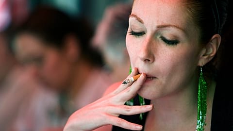 A woman smokes in a restaurant in Mexico City, Wednesday, April 2, 2008