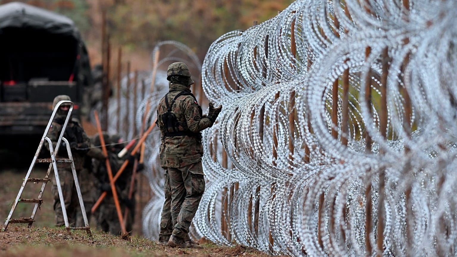 Polish soldiers begin laying a razor wire barrier along Poland’s border with the Russian exclave of Kaliningrad in Wisztyniec, Poland, on Nov. 2, 2022.