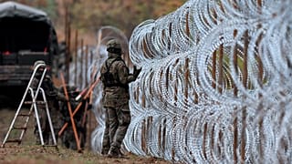 Polish soldiers begin laying a razor wire barrier along Poland’s border with the Russian exclave of Kaliningrad in Wisztyniec, Poland, on Nov. 2, 2022.