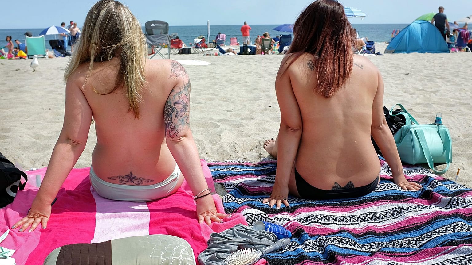 Women topless on the beach as they participate in the Free the Nipple global movement during Go Topless Day in 2017