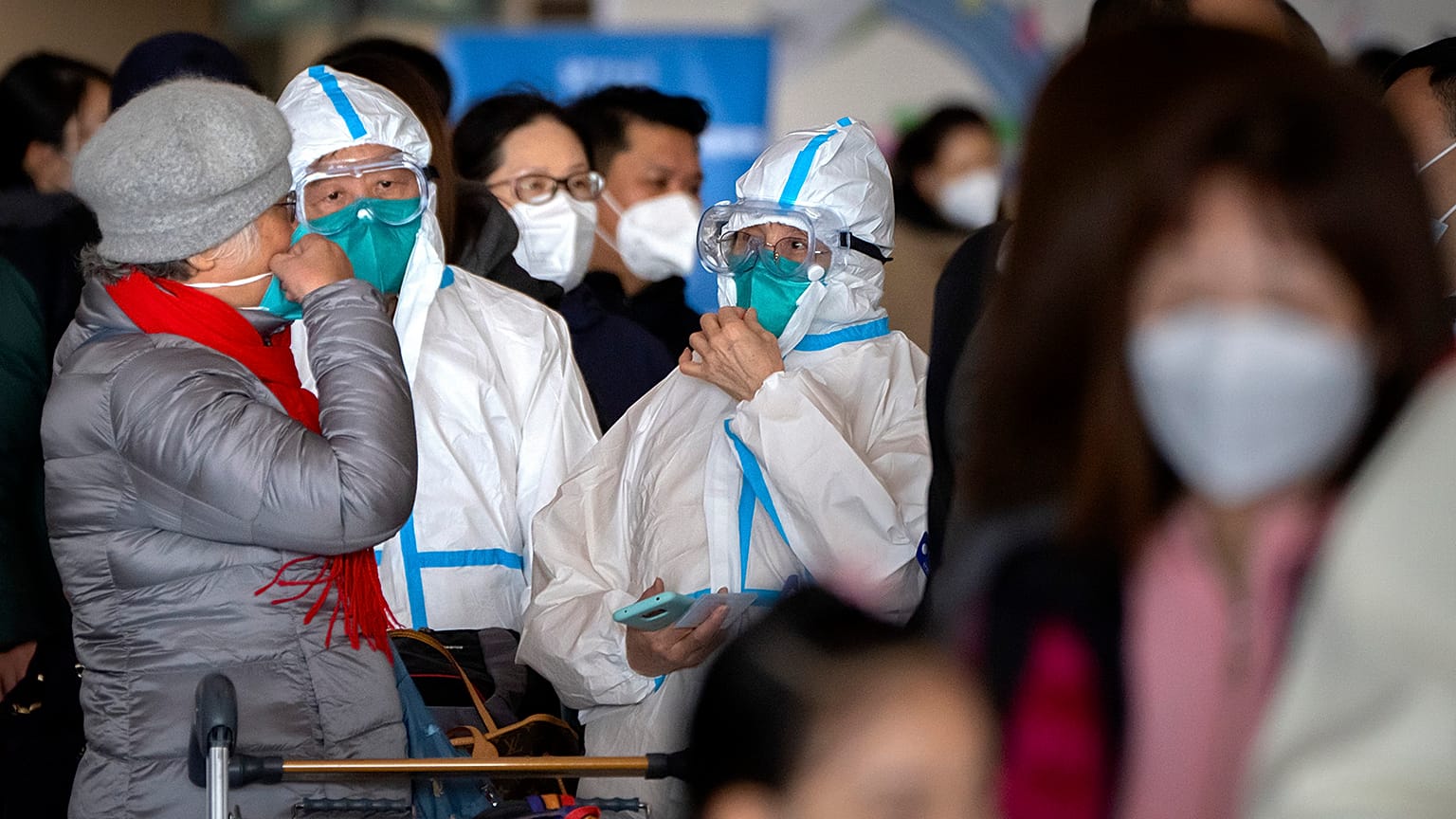 Travellers stand in line to check in for a Cathay Pacific flight to Hong Kong at Beijing Capital International Airport, 15 January 2023